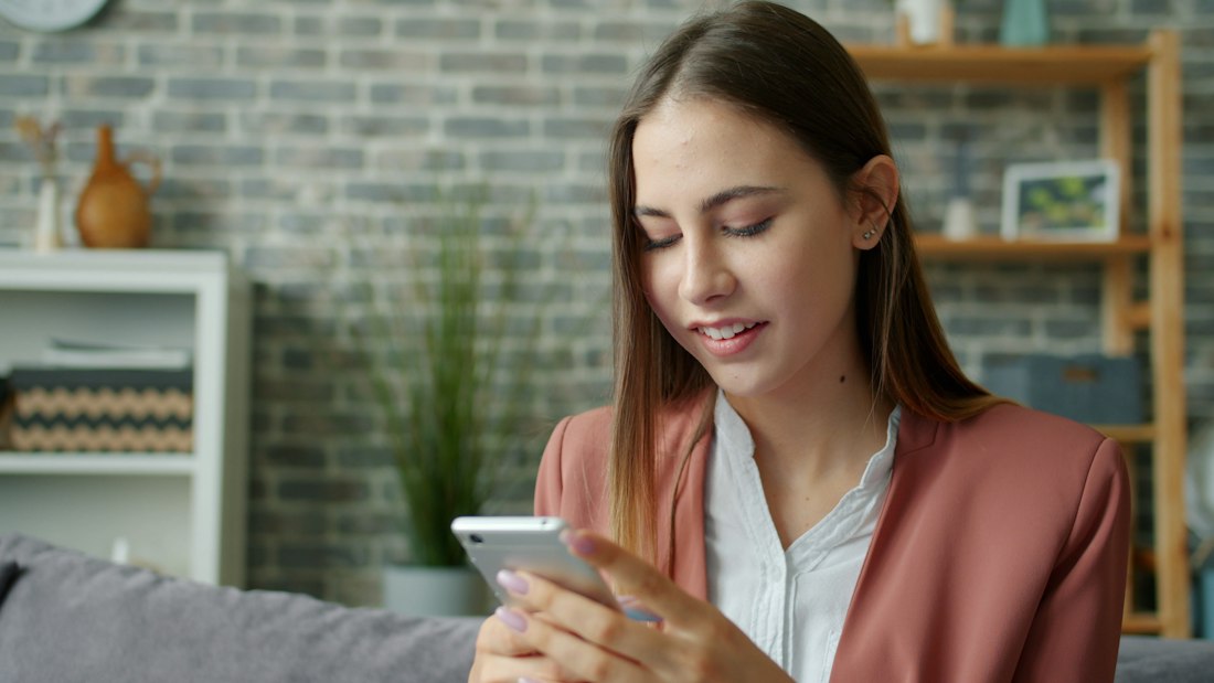 A woman reading a message on her phone